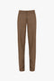 A pair of brown and yellow plaid trousers with a narrow leg silhouette, waistband, and zipper fly is the Victoria Beckham Asymmetric Chino Trouser In Tobacco.