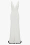 Exclusive V-Neck Gathered Waist Floor-Length Gown In Ivory by Victoria Beckham: Sleeveless white gown with a deep V-neckline and ruching at the waist, extending into a floor-length skirt to create an hourglass silhouette.