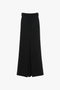 A long, black, high-waisted wool skirt with a front pleat and belt loops at the waist, this Floor-Length Box Pleat Skirt In Black by Victoria Beckham is perfect for any occasion.