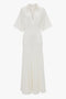 Elegant Panelled Knit Dress In White by Victoria Beckham with short sleeves, collared neckline, two chest pockets, and a flared skirt.