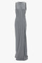 A Frame Detailed Maxi Dress In Titanium by Victoria Beckham, featuring a sleeveless, floor-length gray draped design and a simple round neckline against a white background.