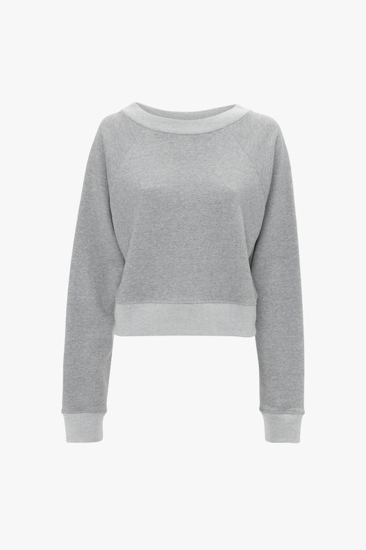A Victoria Beckham light grey marl cropped sweatshirt with long sleeves and a ribbed hem, displayed on a white background.