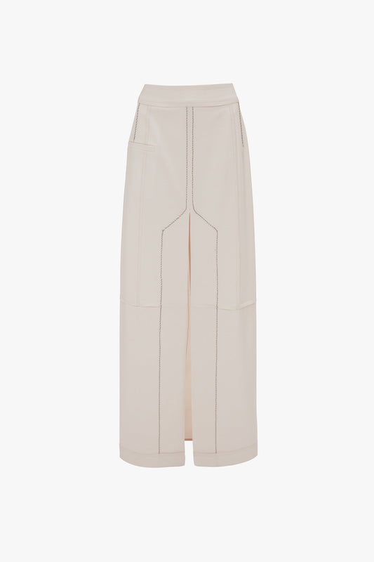 A long beige "Deconstructed Floor-Length Skirt In Bone" by Victoria Beckham with a high waist, visible stitching, two side pockets, and a front slit, displayed on a plain white background.