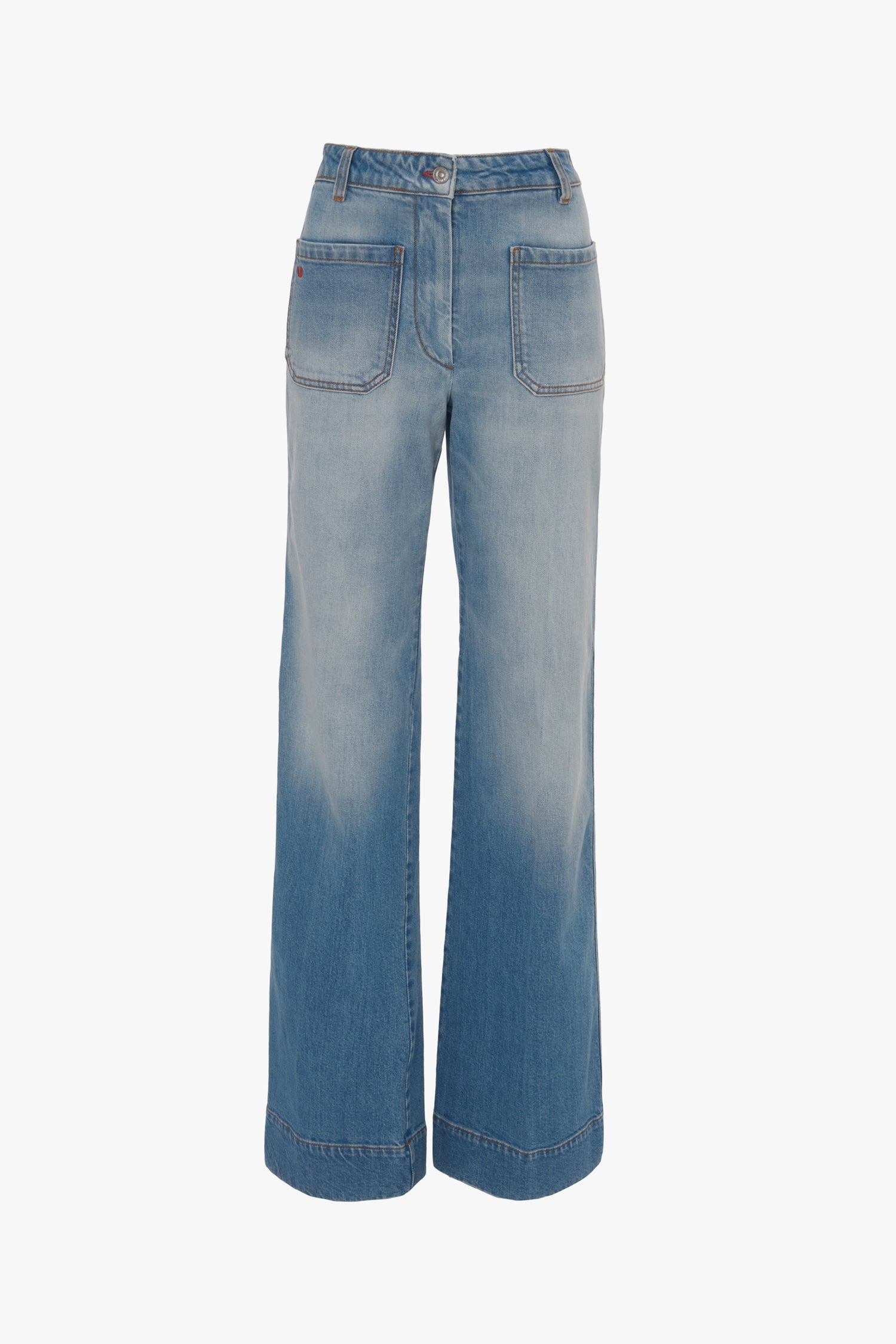A pair of blue wide-leg jeans with front patch pockets and a high waist, crafted in vintage denim style, displayed against a white background: Alina High Waisted Jean In Light Summer Wash by Victoria Beckham.