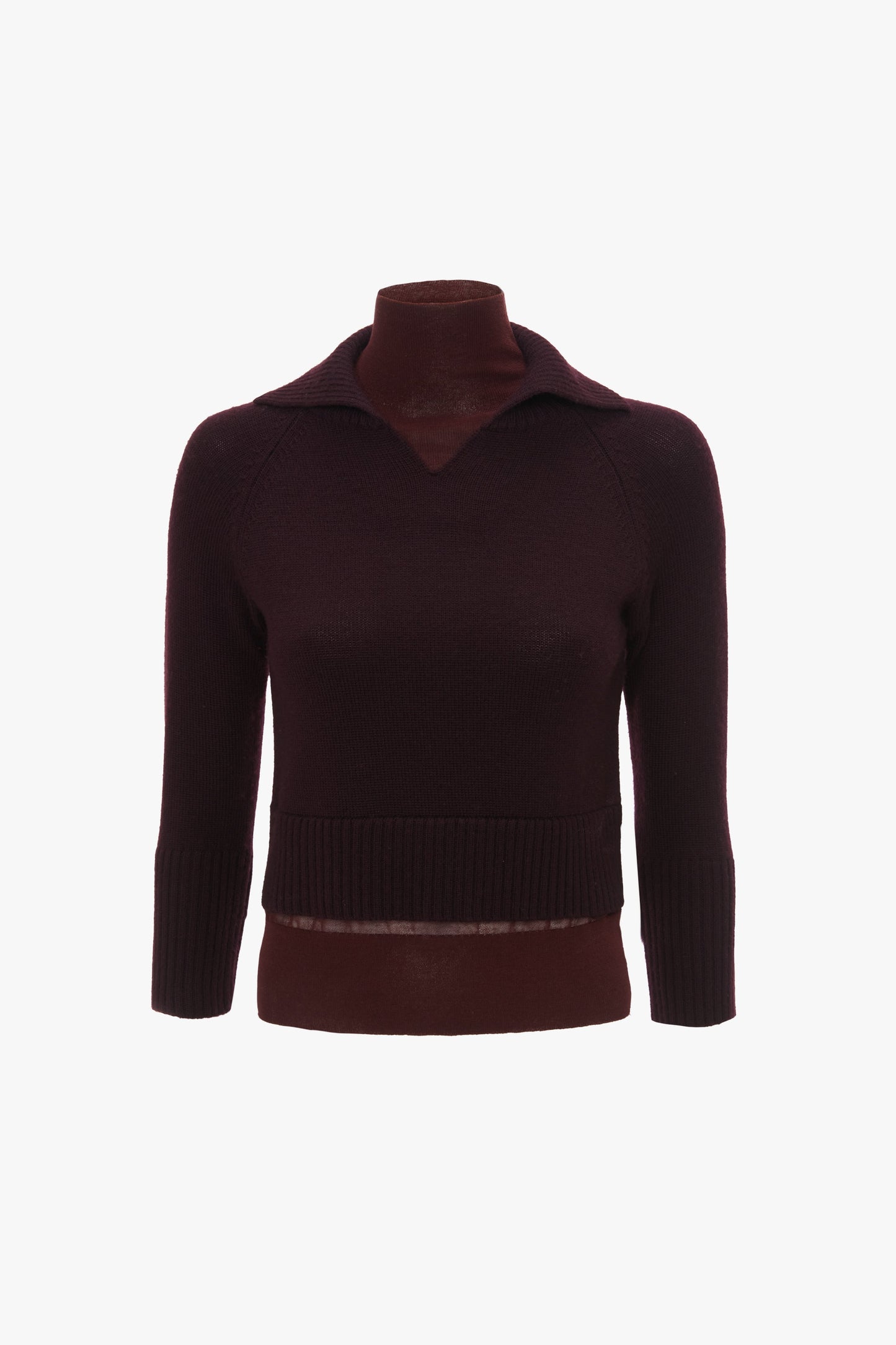 A dark burgundy, long-sleeved Merino wool knit sweater with a V-neckline and a ribbed hem displayed on a mannequin is the **Double Layer Top In Deep Mahogany** by **Victoria Beckham**.