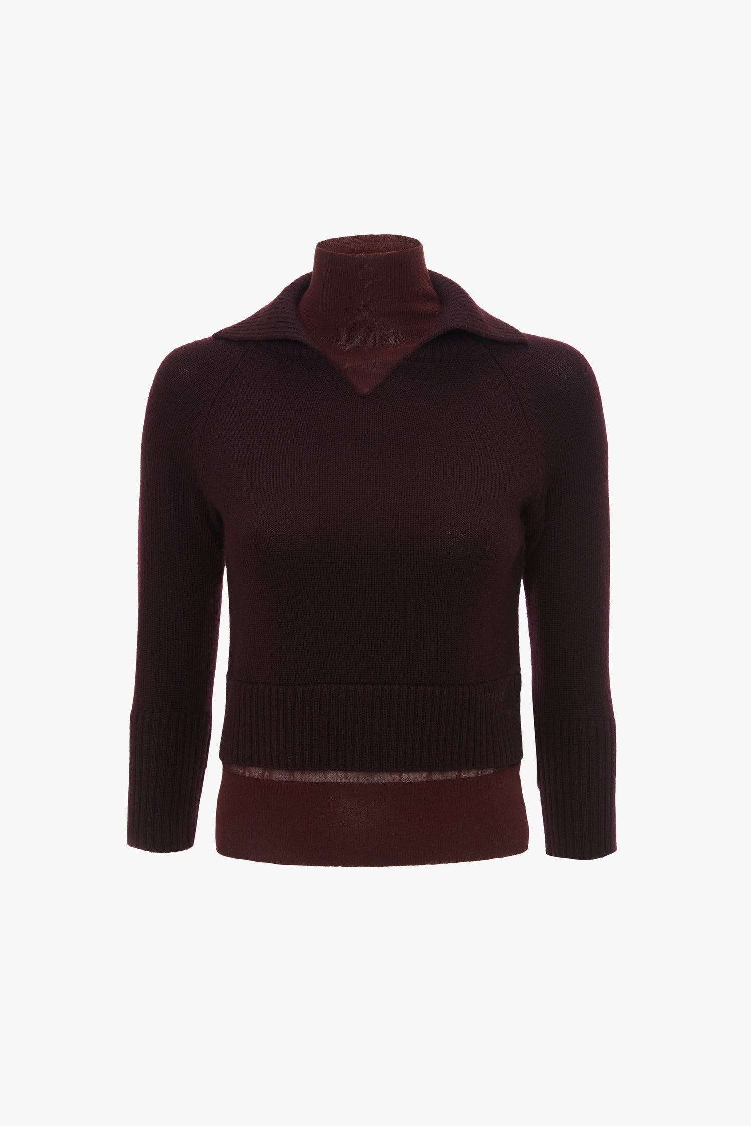 A dark burgundy, long-sleeved Merino wool knit sweater with a V-neckline and a ribbed hem displayed on a mannequin is the **Double Layer Top In Deep Mahogany** by **Victoria Beckham**.