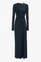 A long-sleeve, floor-length navy blue Ruched Detail Floor-Length Gown In Midnight by Victoria Beckham features gathered ruching on the front and a high neckline, perfect for evening occasions.