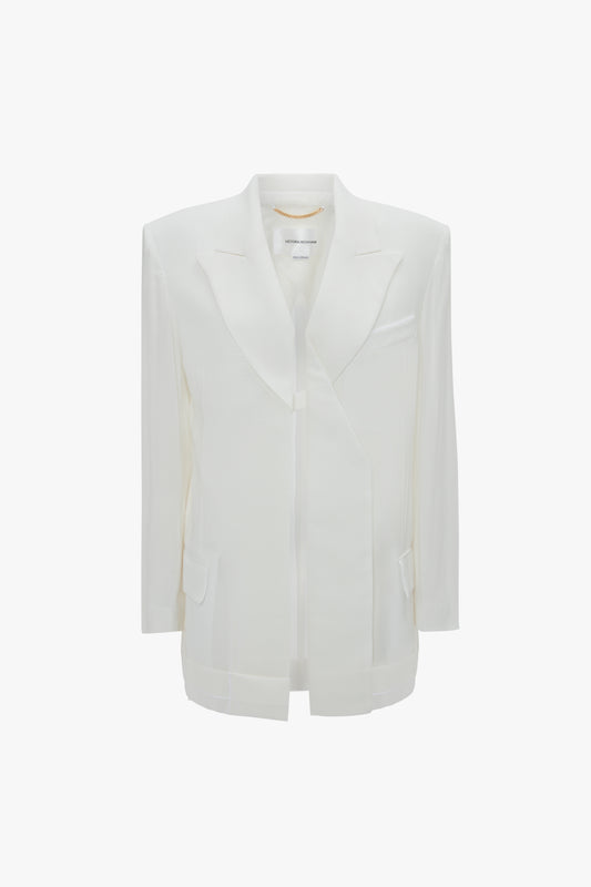 A Victoria Beckham Fold Detail Tailored Jacket In White with a folded satin collar, structured shoulders, and multiple pockets on the front.