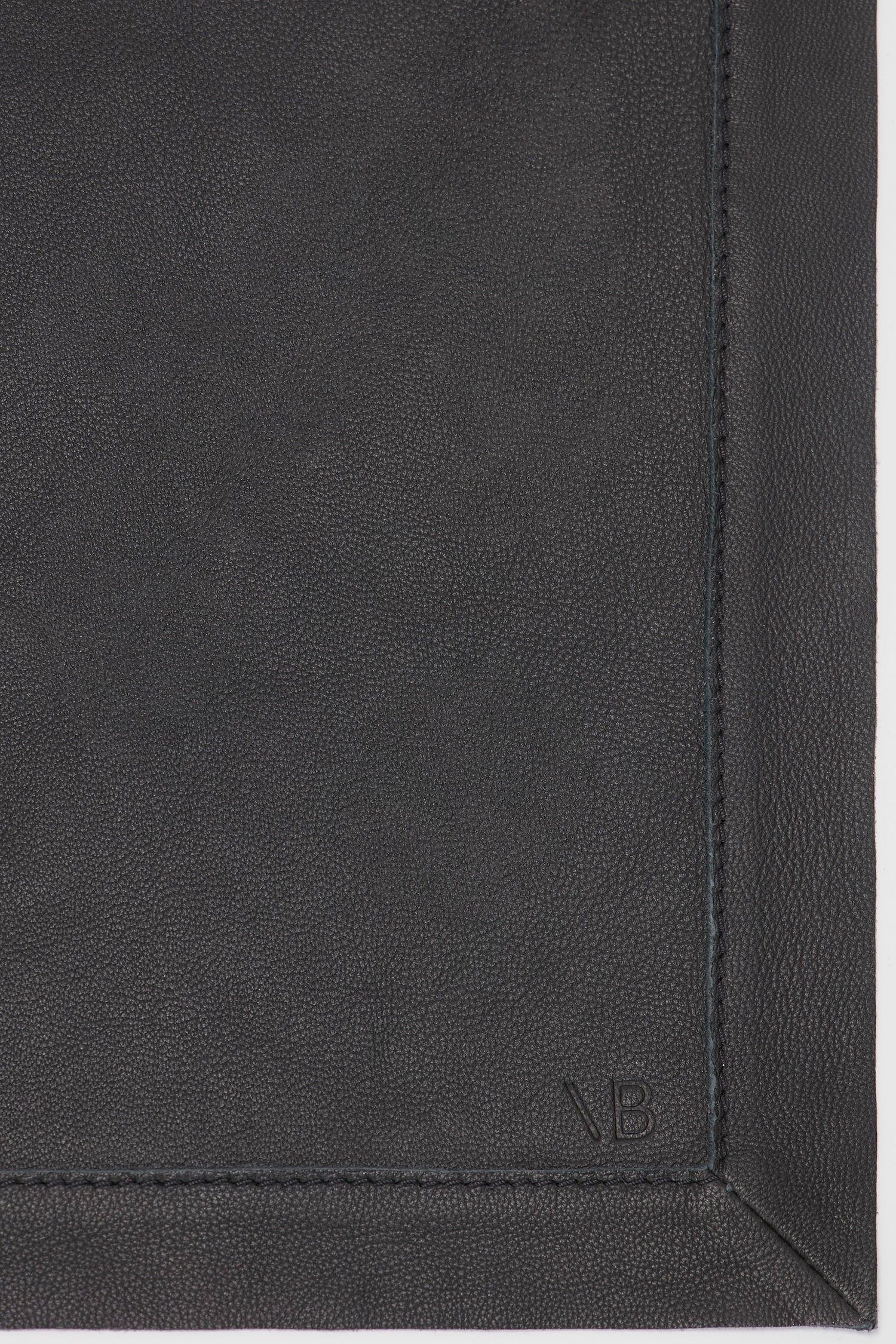 Close-up of a Victoria Beckham Foulard In Black Leather with a subtle embossed logo at the bottom and visible stitching on the sides.