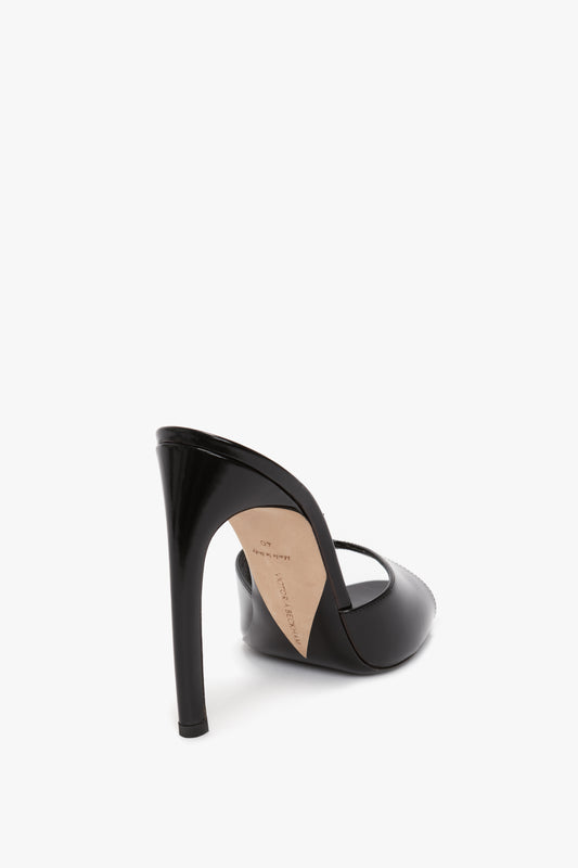 A Victoria Beckham Classic Mule In Black Calf Leather viewed from the back and side, showcasing its classic mule design with a seductive curved heel.