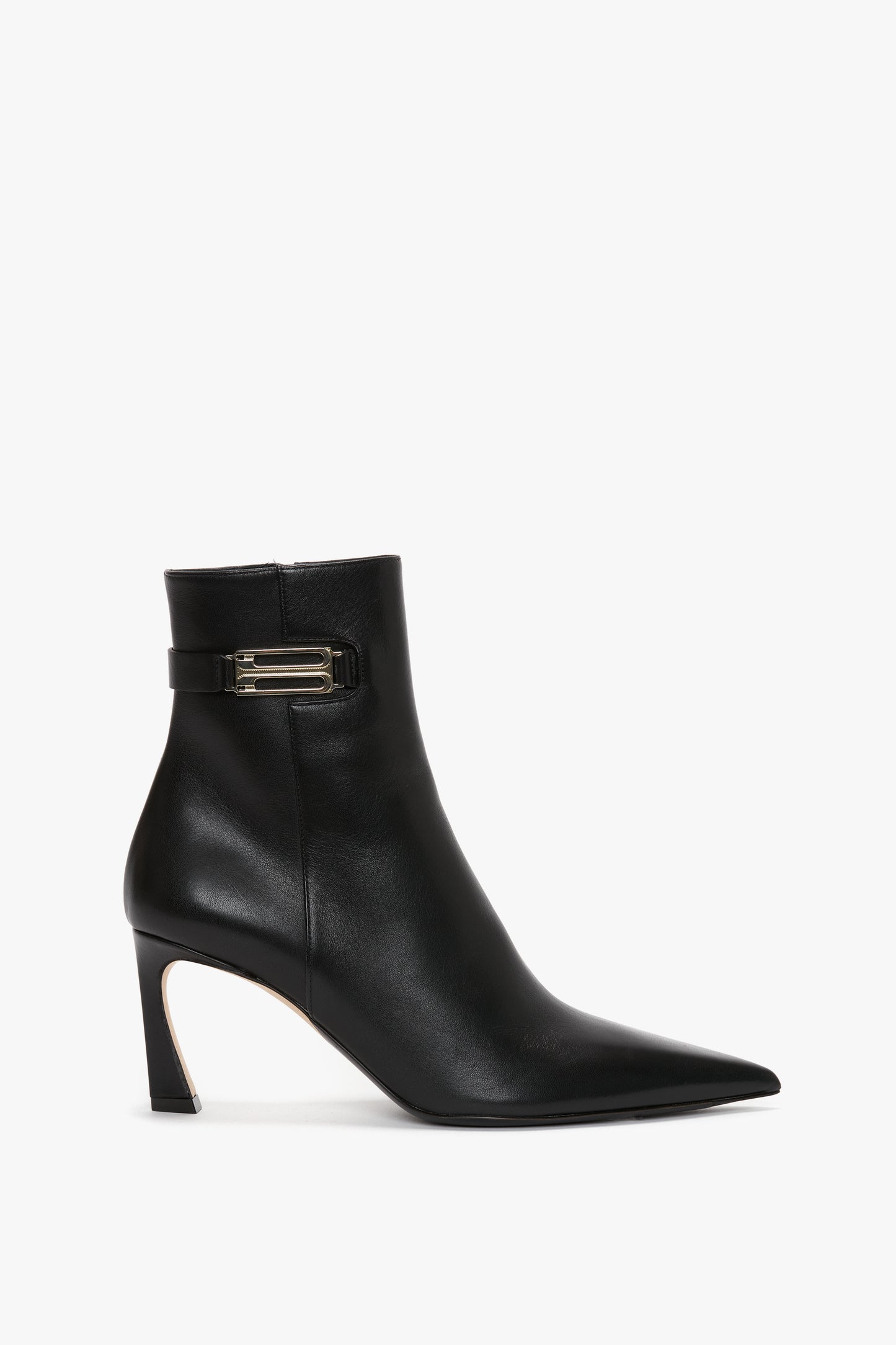 Pointed Toe Half Boot In Black Soft Calf Leather crafted from calf leather with a pointed toe, side buckle, and a mid-height heel against a white background by Victoria Beckham.