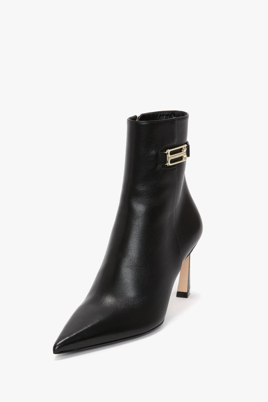 A Victoria Beckham Pointed Toe Half Boot In Black Soft Calf Leather with a silver buckle detail near the top.