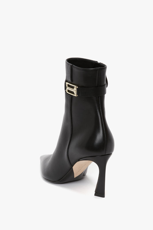Pointed Toe Half Boot In Black Soft Calf Leather by Victoria Beckham with a pointed toe, stiletto heel, and a gold buckle on the side.