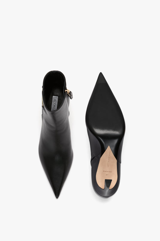 Top-down view of a pair of Victoria Beckham Pointed Toe Half Boot In Black Soft Calf Leather, one showing the top and the other showing the sole.