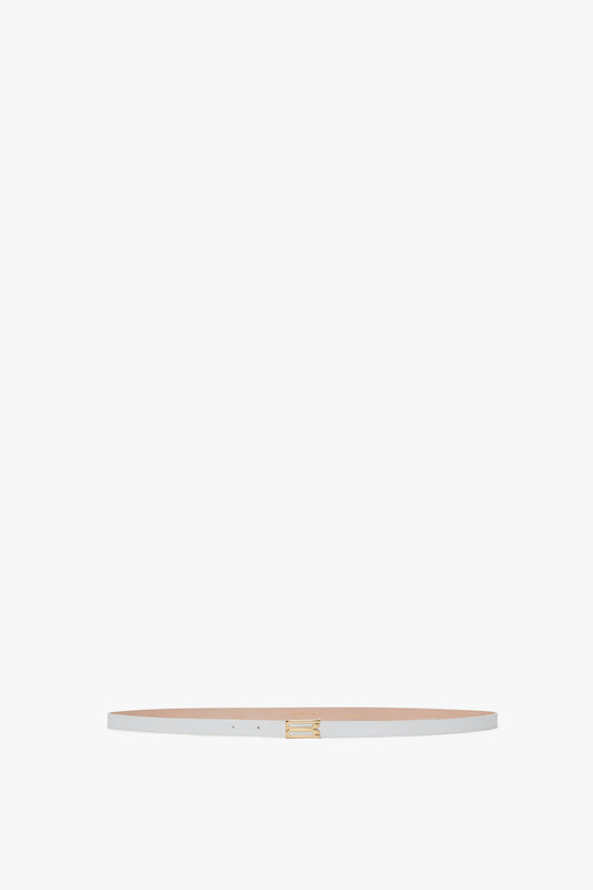 A narrow, tan calf leather Exclusive Micro Frame belt from Victoria Beckham with a small gold buckle, displayed horizontally against a white background.