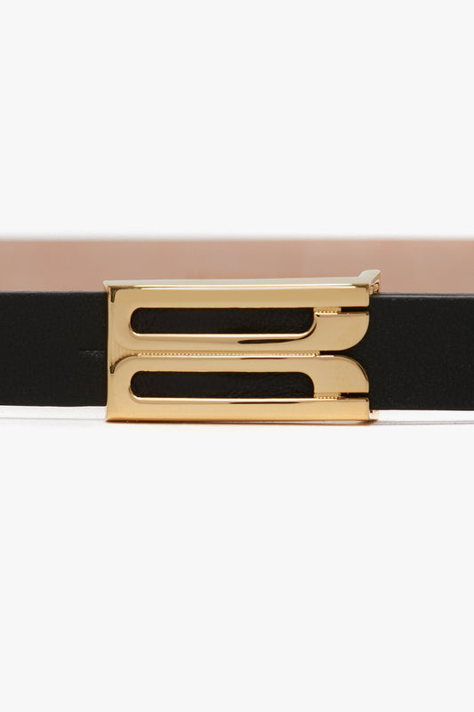 Close-up of a Victoria Beckham Exclusive Micro Frame Belt In Black Leather with a gold rectangular buckle, isolated on a white background.