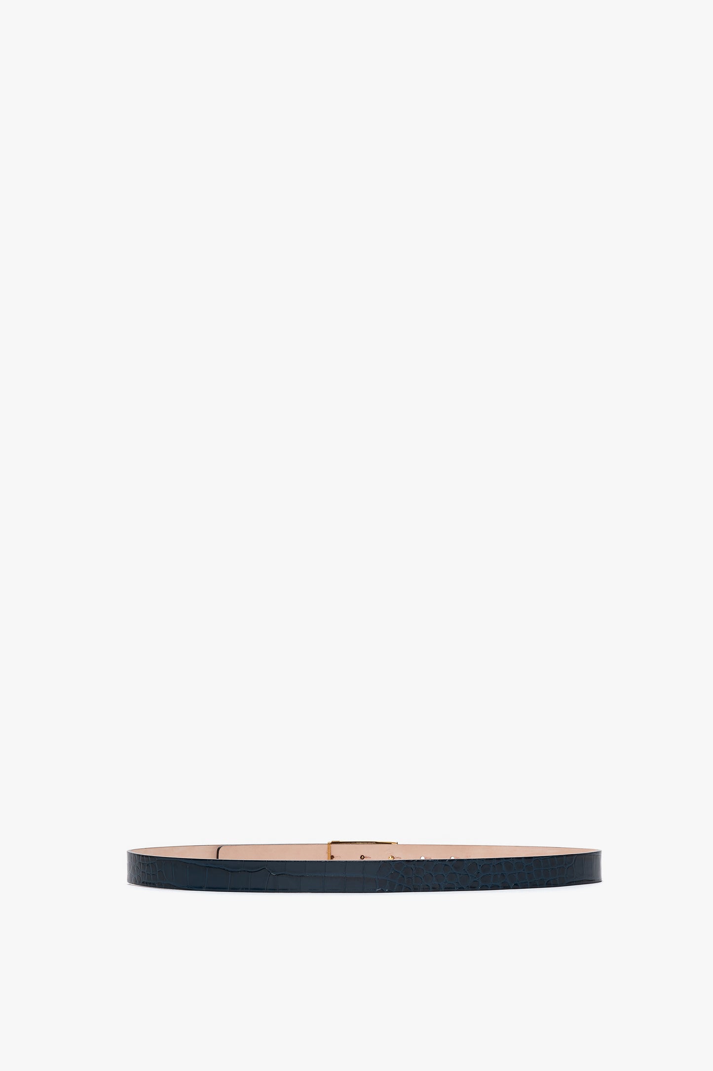 A thin, dark-colored croc-embossed calf leather belt with a flat rectangular buckle and gold hardware is shown on a white background. The product is the Frame Belt in Midnight Blue Croc Embossed Calf Leather by Victoria Beckham.