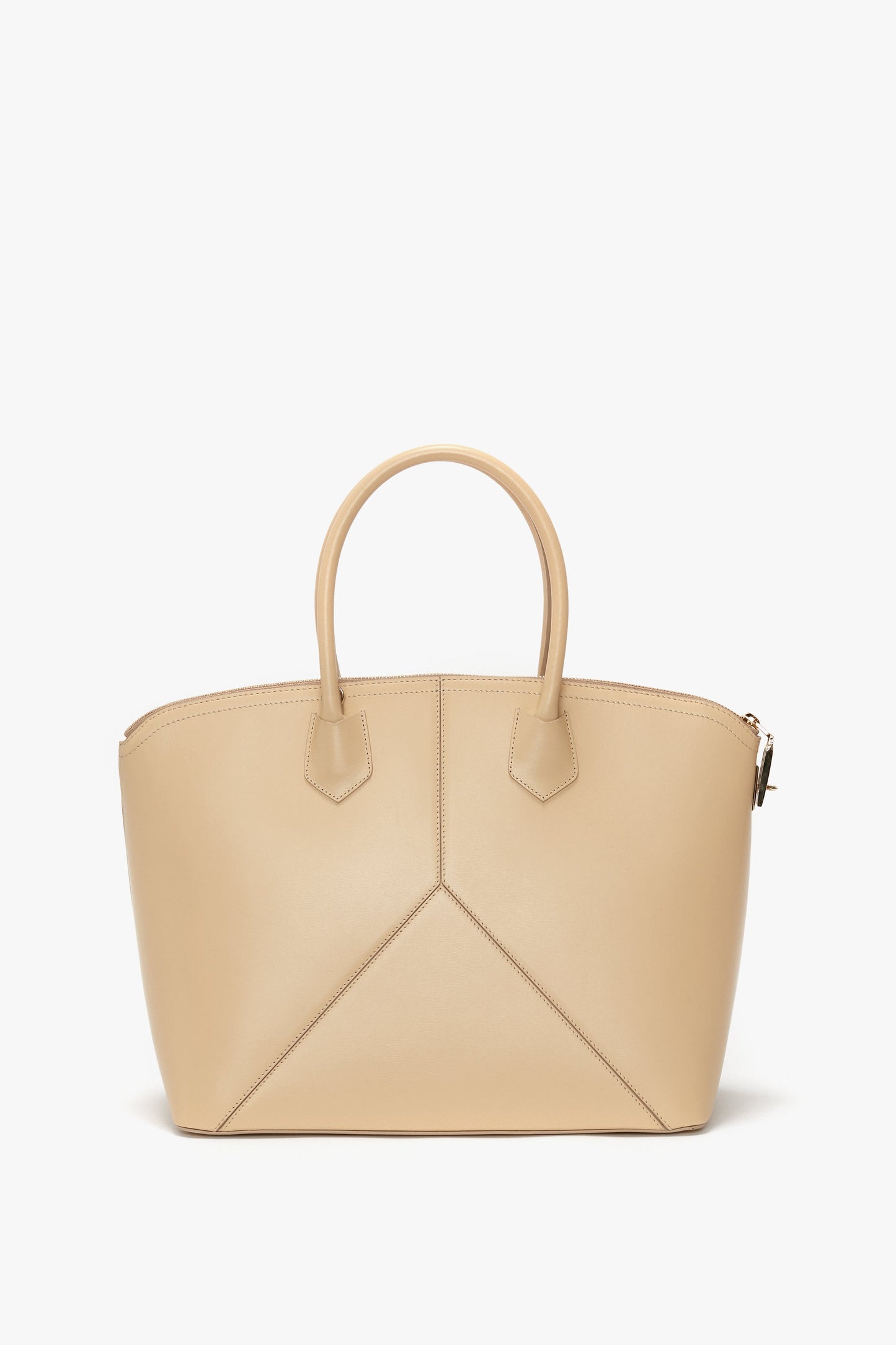 The Victoria Beckham Victoria Bag In Sesame Leather: a beige leather handbag featuring two short straps and intricate geometric leather panels on the front.
