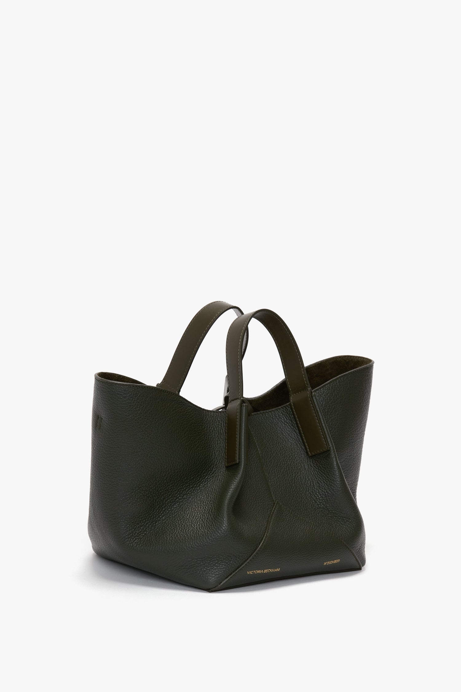 A large, dark green leather W11 Mini Tote Bag In Loden Leather with two sturdy handles and a spacious interior, crafted from luxurious suede by Victoria Beckham.