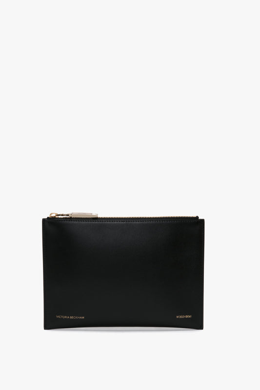 A black calf leather B Frame Pochette by Victoria Beckham, featuring a gold-tone zip and brand name in gold at the bottom right.