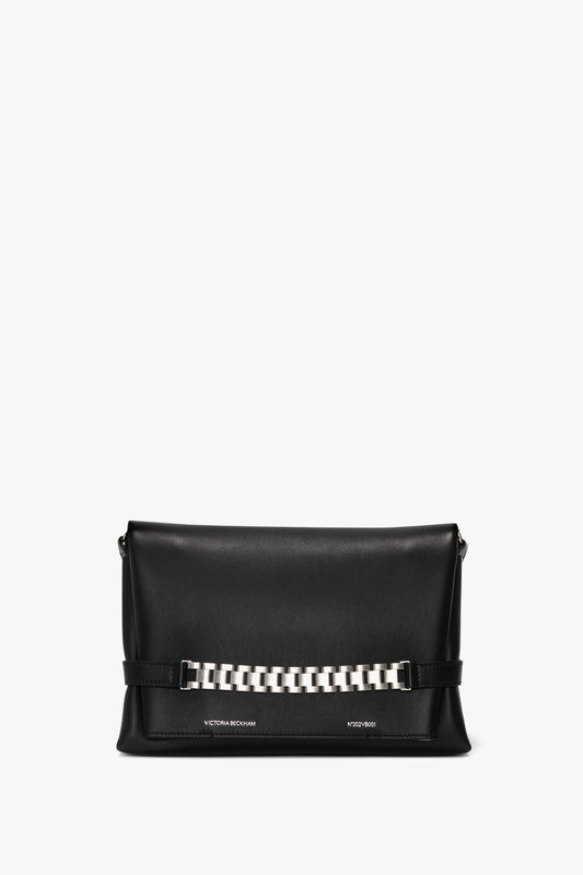 Black leather Chain Pouch Bag with Brushed Silver Chain In Black Leather with a silver chain accent on the front and subtle silver Victoria Beckham branding along the bottom. Comes with a detachable strap for versatility.