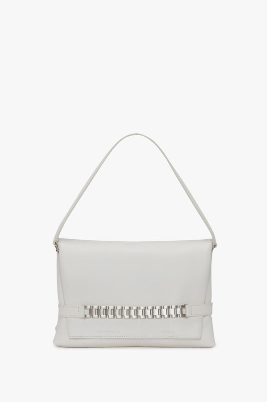A Chain Pouch with Brushed Silver Chain In White by Victoria Beckham with a single top handle, a decorative woven pattern on the front, and foil-embossed branding.