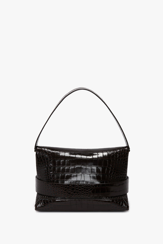 A black, calf leather B Pouch Bag In Croc Effect Espresso Leather by Victoria Beckham featuring an embossed crocodile print with a single handle and a rectangular shape, photographed against a white background.