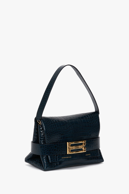 B Pouch Bag In Croc Effect Midnight Blue Leather by Victoria Beckham, featuring a gold buckle closure and a single strap.