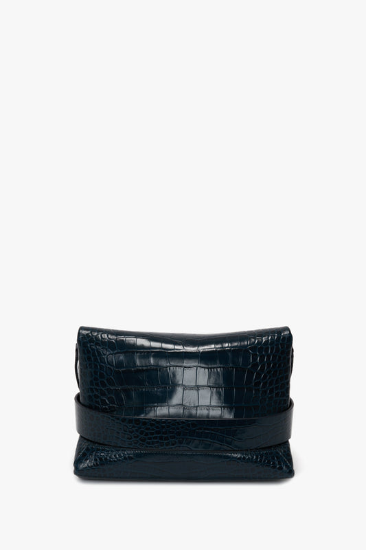 B Pouch Bag In Croc Effect Midnight Blue Leather crafted from crocodile-embossed leather by Victoria Beckham, featuring a sophisticated fold-over closing design, set against a white background.