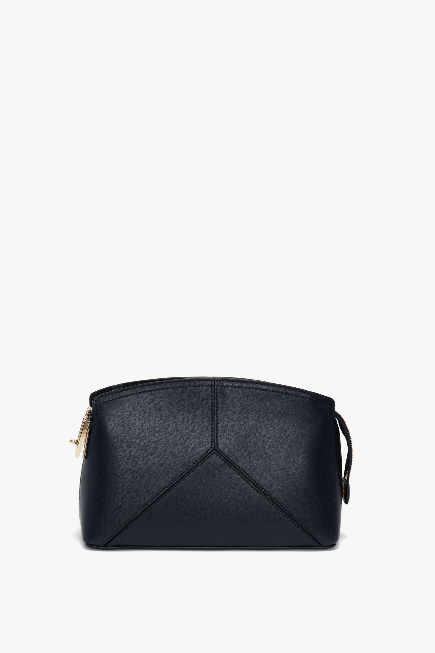 A Navy leather handbag with minimalistic design, featuring subtle stitching details and a gold zipper closure on the left side. This versatile clutch bag is perfect for any occasion. The **Exclusive Victoria Crossbody Bag In Navy Leather** by **Victoria Beckham** encapsulates both style and functionality, making it an ideal choice for any event.