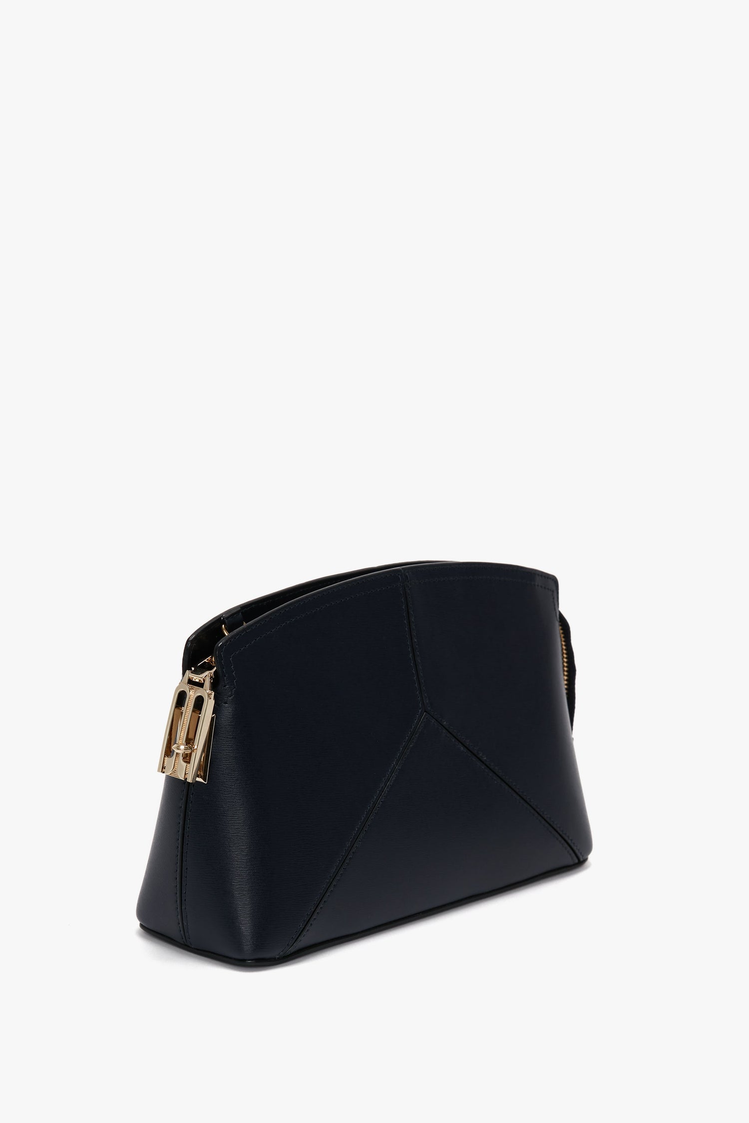 A Victoria Beckham Exclusive Victoria Crossbody Bag In Navy Leather, featuring a structured design and geometric stitching details.