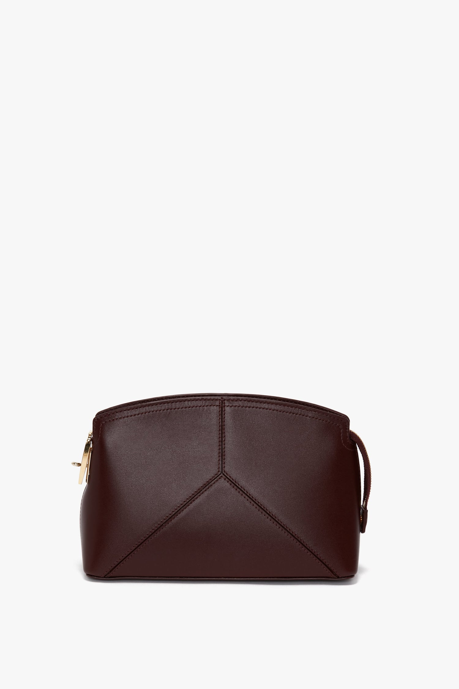 A Victoria Crossbody Bag In Burgundy Leather by Victoria Beckham, crafted from textured calf leather with a geometric design and a gold zipper, rests on a white background.