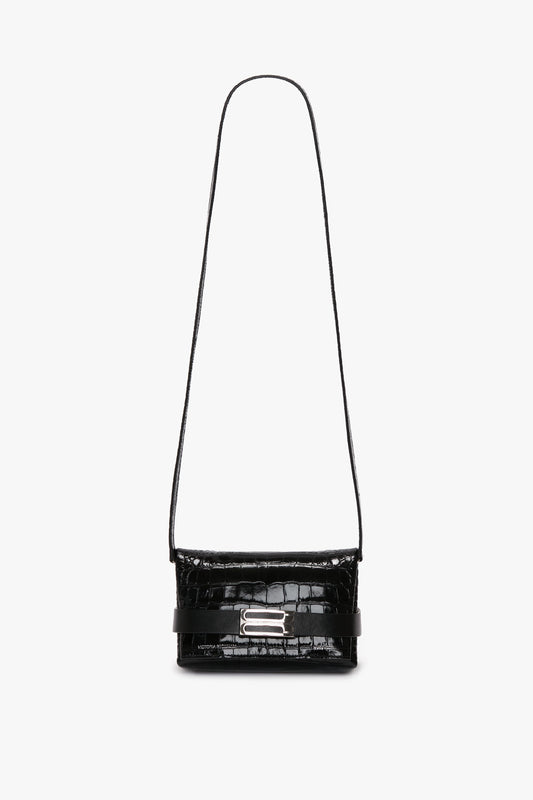A Mini B Pouch In Croc Effect Black Leather by Victoria Beckham with a silver clasp on the front and a single strap.