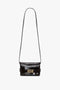 A small black Victoria Beckham Mini B Pouch Bag In Croc Effect Espresso Leather with a long detachable crossbody strap and a gold buckle on the front.