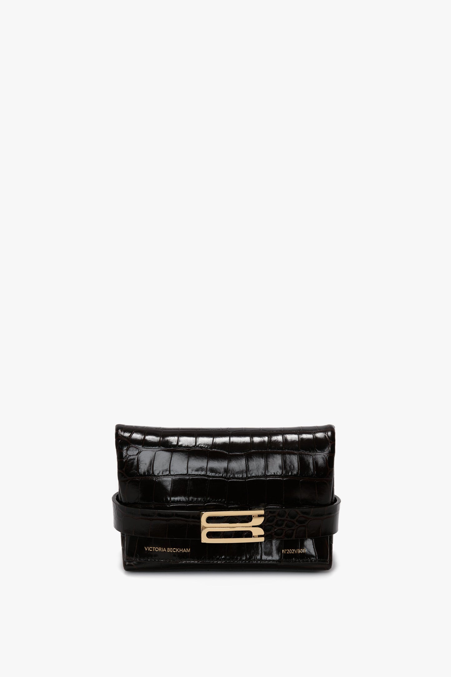 A Mini B Pouch Bag In Croc Effect Espresso Leather in luxurious calf leather with a gold-tone clasp, featuring the brand "Victoria Beckham" printed in gold at the bottom. This elegant piece includes a detachable crossbody strap for versatile wear.