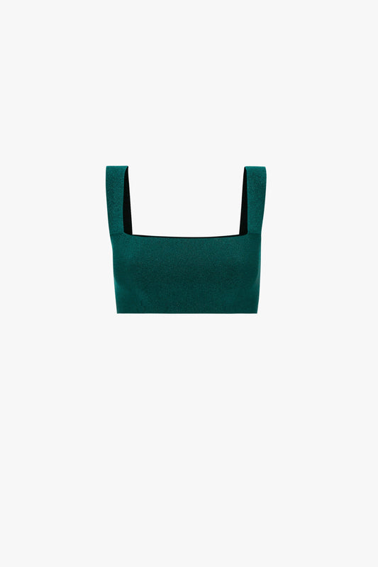A dark green, square-neck crop top with wide shoulder straps, displayed against a white background, pairs perfectly with a VB Body Flared Skirt. [Victoria Beckham VB Body Strap Bandeau Top In Lurex Green].