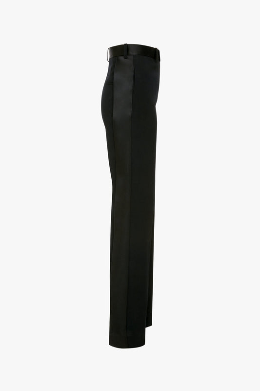 A pair of black Satin Panel Straight Leg Trousers by Victoria Beckham viewed from the side, featuring belt loops and a straight-leg design, perfect for modern evening wear.