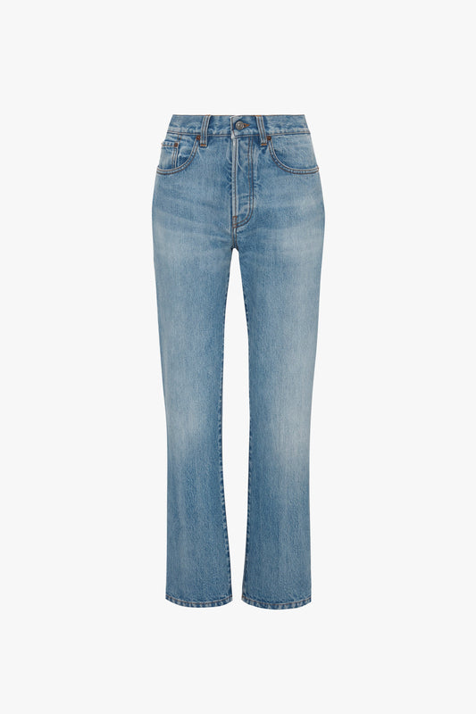A pair of Victoria Beckham Victoria Mid-Rise Jean In Light Blue, featuring five pockets and a button and zipper fly, shown against a white background.
