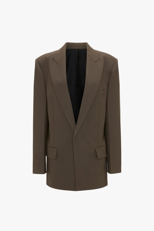 A Peak Lapel Jacket In Oregano by Victoria Beckham with a deep V-neck, structured shoulders, two front pockets, and a chest pocket against a plain white background offers a contemporary aesthetic with its slight oversized silhouette.