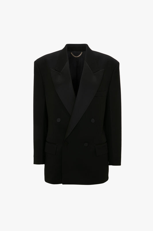 A Satin Lapel Tuxedo Jacket in Black by Victoria Beckham, with satin lapels and gold chain detail on the interior neck, displayed against a white background.