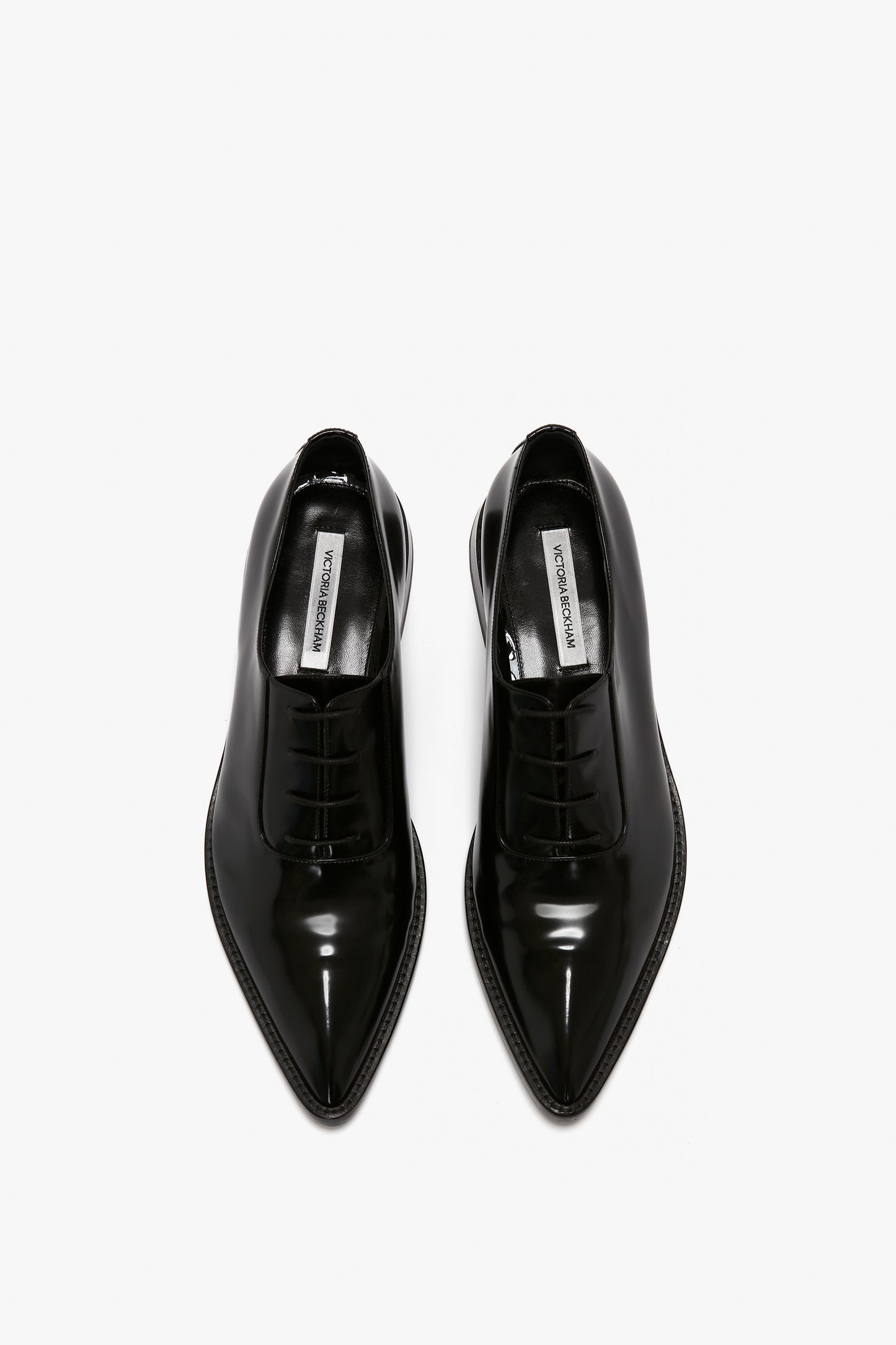 A pair of Victoria Beckham Pointy Toe Flat Lace Up In Black Brushed Leather shoes viewed from the top against a white background.