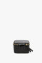 A small, square, black croc leather case with a textured pattern and a gold zip closure, shown closed against a white background is the Jewellery Box In Black Croc-Effect Leather by Victoria Beckham.