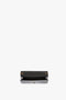 Black open rectangular Wallet On Chain In Black Croc-Effect Leather by Victoria Beckham with a visible interior compartment and an elegant golden chain strap.