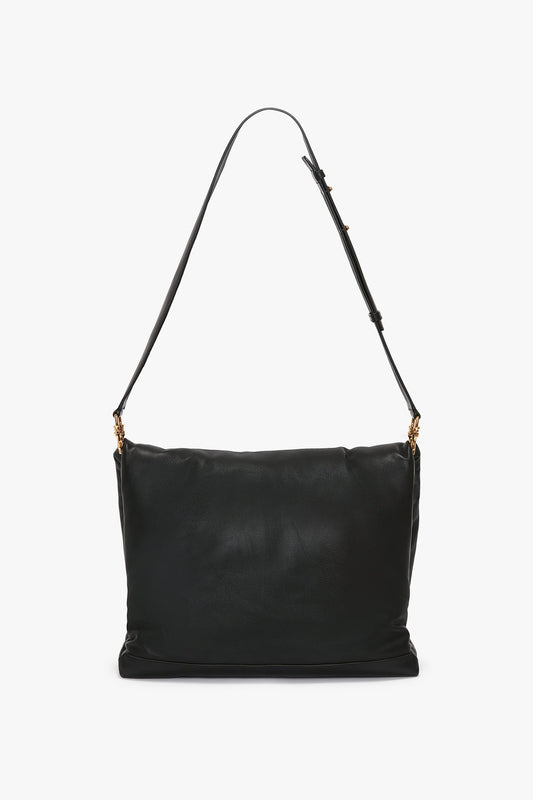 Puffy Jumbo Chain Pouch In Black Leather by Victoria Beckham with an adjustable strap and puffy jumbo chain pouch detailing, complemented by gold-tone hardware.