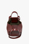 A W11 Medium Tote Bag In Burgundy Leather crafted by Victoria Beckham with an open top, two handles, and a detachable shoulder strap. The interior is lined with dark material.