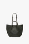 Victoria Beckham W11 Jumbo Tote Bag In Loden Leather crafted from luxury grained leather, featuring dual adjustable shoulder straps and a simple design.