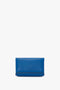 A Victoria Beckham Mini Chain Pouch Bag With Long Strap In Sapphire Blue with a smooth texture and minimal design against a white background.