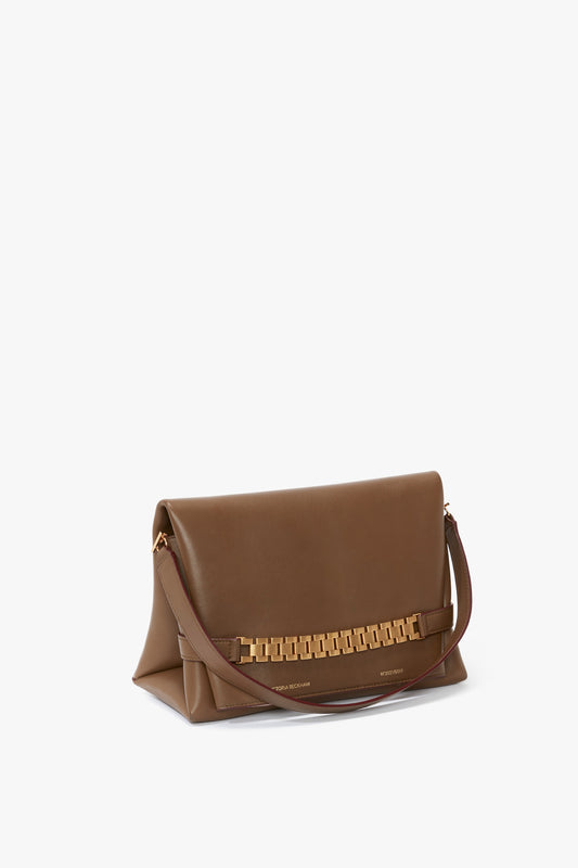 Victoria Beckham Chain Pouch Bag With Strap In Khaki Leather with a gold chain detail on the front flap and a single, detachable shoulder strap.