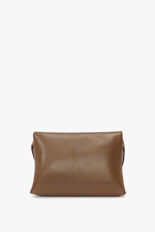 A Chain Pouch Bag With Strap In Khaki Leather by Victoria Beckham with a simple, rectangular design, featuring a smooth surface, minimal stitching, and a detachable strap.