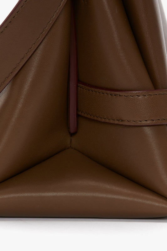 Close-up of a Victoria Beckham Chain Pouch Bag With Strap In Khaki Leather with a minimalist design, crafted from Nappa leather, featuring a smooth surface and neat stitching details.